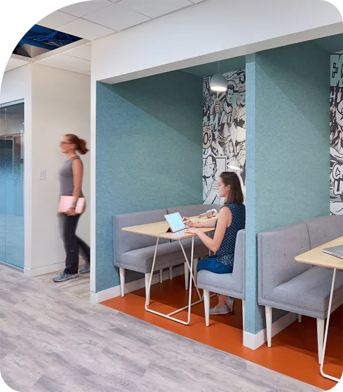 A woman sits at a coworking space.