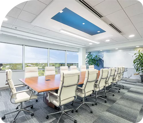 A conference room with a large table and chairs in a home setting.