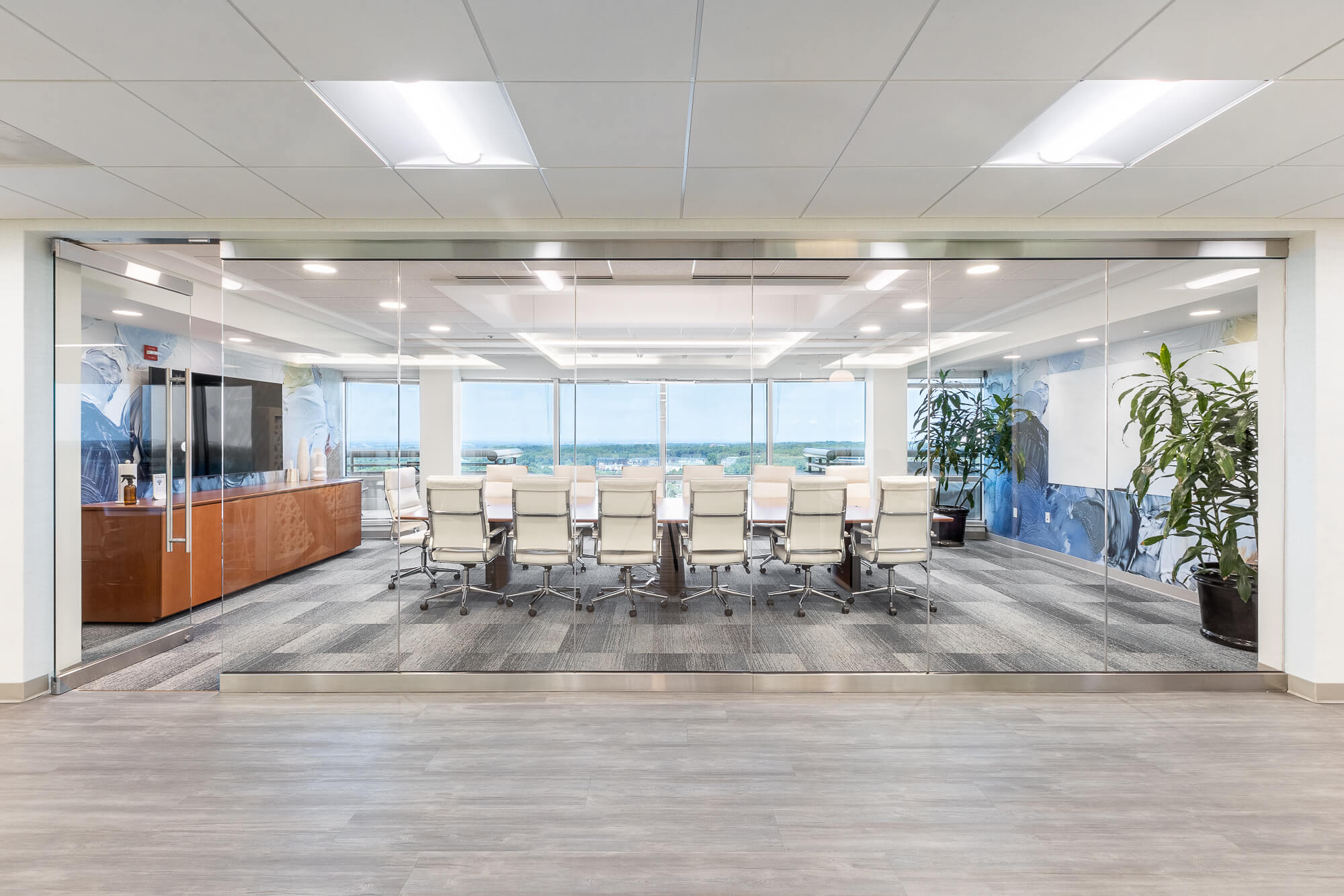 A home conference room with glass wall and chairs.