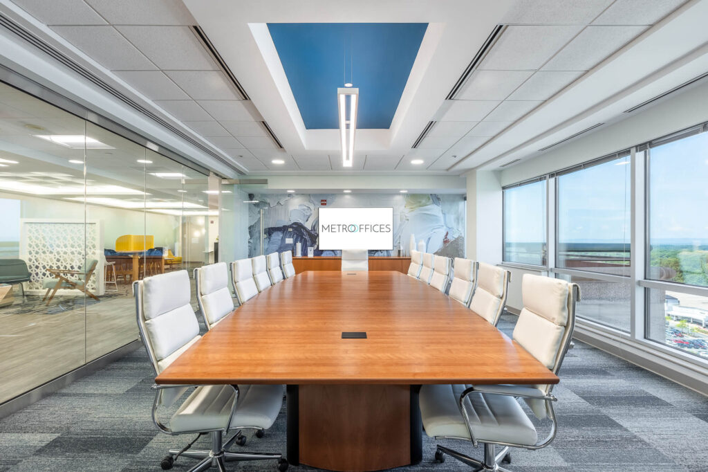 A meeting room with a large table and chairs.