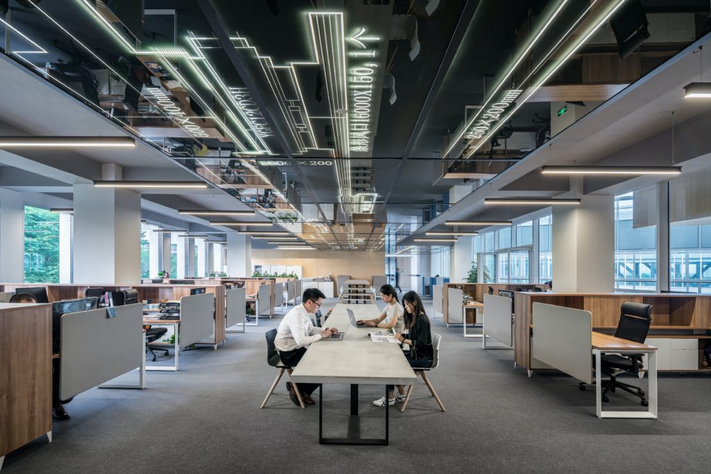 People sitting around a big office space.