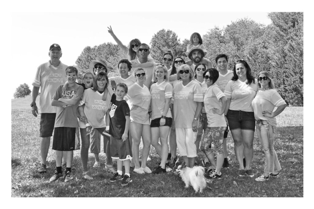 A group of people posing for a photo at an outdoor event hosted by Metro Offices, some wearing matching t-shirts.