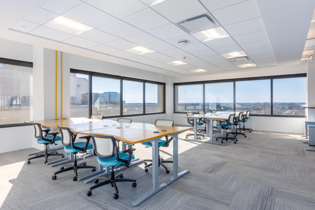 A conference room with tables and chairs in suites.